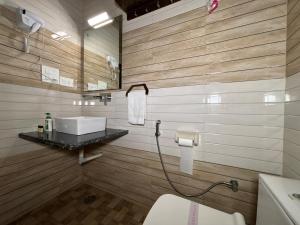 a bathroom with a sink and a toilet in it at The Orchid Retreat in Agra +84 photos