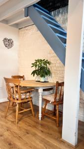 a dining room with a table with chairs and a plant at Poplar farm annexe in Beverley +31 photos