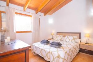 a bedroom with a bed with towels on it at 113 Finca Can Roig ETV955 by Mallorca Charme in Alcudia +36 photos