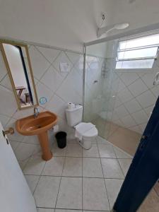 a bathroom with a sink and a toilet and a shower at Pousada Rafimar in Ilhabela