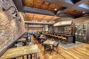 a restaurant with tables and chairs and a brick wall at The Lodge at Deadwood in Deadwood