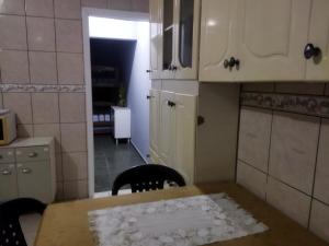 a small kitchen with a table and a dining room at Casa completa para 4 pessoas in Itu
