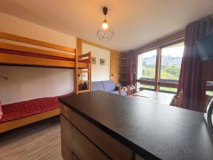 a bedroom with a bunk bed and a large window at Studio lumineux avec balcon, au pied des pistes, Les Menuires – 3 personnes - FR-1-452-17 in Les Menuires