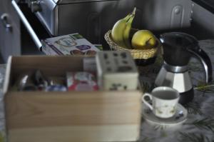 a table with a basket of bananas and a coffee cup at Pinerolo medievale in Pinerolo +30 photos