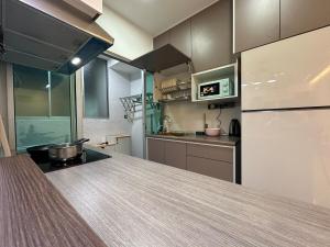 a kitchen with a counter top and a refrigerator at KL ,2BR 2Bath Condo ,Razak city ,TV box&Pool in Kuala Lumpur +19 photos