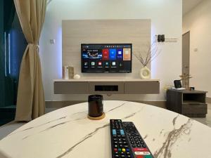 a remote control sitting on a table in front of a tv at KL ,2BR 2Bath Condo ,Razak city ,TV box&Pool in Kuala Lumpur