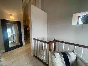 a hallway with a staircase and a mirror in a room at Apartamentos El Hospital de Villahormes in Villahormes