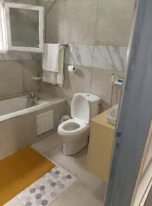 a small bathroom with a toilet and a sink at Residence Merveilles CM15 in Kribi +75 photos