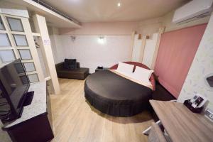 a bedroom with a large bed in a room at The Riverside Hotel Fashion in Kaohsiung