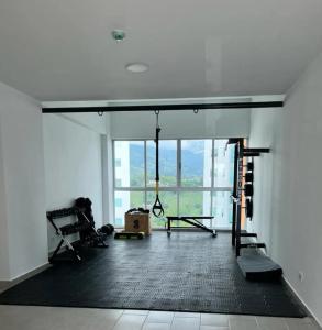 an empty room with a gym with a large window at Belmonte Studios perfect location with pool cowork and amazing view in Armenia