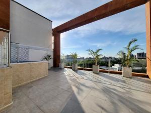an open balcony with palm trees on a building at Belmonte Studios perfect location with pool cowork and amazing view in Armenia