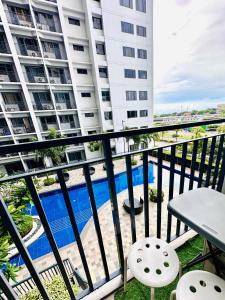 a balcony with a view of a building at Shore Bliss Staycation MOA in Manila