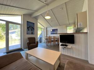a living room with a couch and a table at Strandhaus Dünenpark 1c in Priwall
