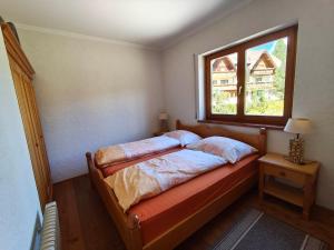a bed in a room with a window at Apartment Berg & See in Turracher Hohe +28 photos