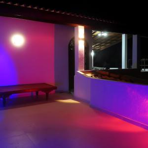 a room with a bench and purple lights at Holiday Home - SuSu Villa in Arangala