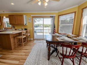a kitchen and dining room with a table and chairs at Lakeside Retreat 2hrs from Boston in Stoddard