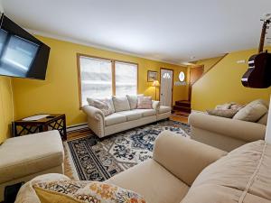 a living room with couches and a flat screen tv at Lakeside Retreat 2hrs from Boston in Stoddard