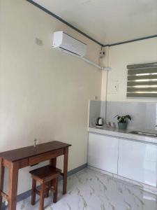 a kitchen with a table and a sink and a refrigerator at Octagon in Caylaway