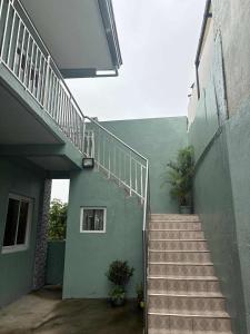 a stairway leading up to a building with a stair case at Octagon in Caylaway