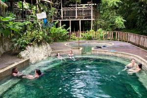 a group of people swimming in a swimming pool at La posada in Nuquí