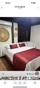 a hotel room with two beds with red sheets at Chalé em Barreirinhas 550,00 6 pessoas in Itaqui