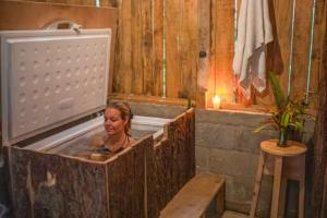 a woman is sitting in a bath tub at Venga Atitlan in San Marcos La Laguna