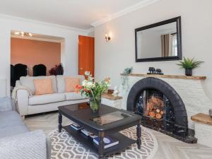 a living room with a couch and a fireplace at Hebridean Country House in Lochs