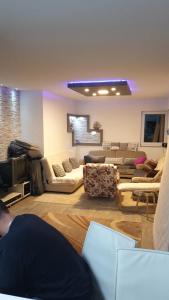 a living room with couches and a tv at Kuća snova in Ilijaš