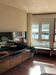 a living room with a large flat screen tv at El rincón de Carolina in O Barqueiro