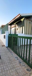 a green fence in front of a house at Villa JALD in Abades