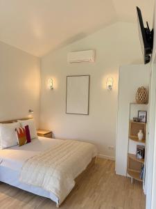 Un dormitorio con una cama y dos luces en la pared. en Cozy studio with air conditioning & pool & parking, en Aix-en-Provence 4 fotos más