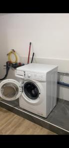 a white washing machine sitting in a room at GünON Houses 19 in Linz