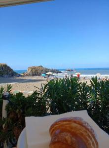 a plate of food with a view of the beach at Casa Vacanza Don Carmelo in Marina di Ascea +11 photos