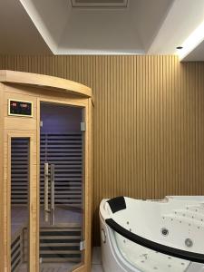 a bathroom with a bath tub and a jacuzzi tub at Escapade dans le Jura 