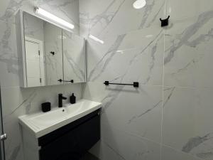 a white bathroom with a sink and a mirror at Caesar Resort Saturn Home Beach in İskele +31 photos