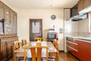 a kitchen with a table and chairs in a kitchen at グループ宿泊に最適 Spacious Home Base by Yadoya in Yokkaichi