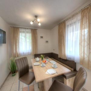 a dining room with a wooden table and chairs at Bergadler in Iselsberg