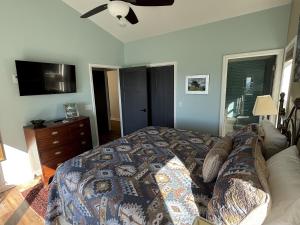 a bedroom with a bed and a flat screen tv at Mayapple - Upstairs in Spruce Pine