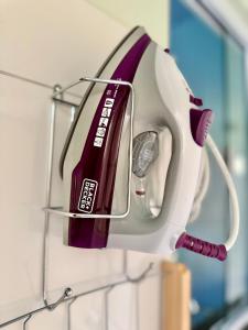 a hair dryer is hanging on a wall at Ap conforto no centro de Sinop 2 in Sinop