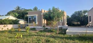 a house with a garden in front of it at Mihambos one bedroom in Msambweni