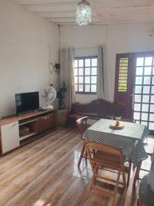 a living room with a table and chairs and a couch at Casa Éden in Guajiru +19 photos