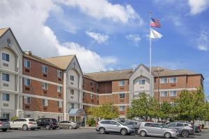 a flag on a pole in front of a building at Sonesta Simply Suites Boston Burlington in Burlington