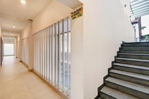 a hallway of a building with stairs and windows at OAK Edassery's Sealine Villa Stay in Cochin
