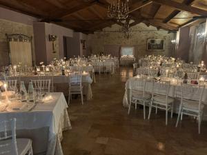 a room filled with tables and chairs with white linens at Agriturismo Tenuta Filippi in Narni