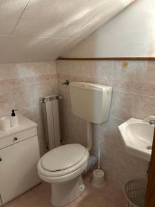 a bathroom with a white toilet and a sink at L' Antica Sosta in Abbadia San Salvatore