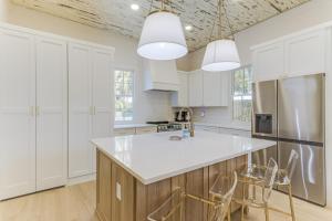 a kitchen with white cabinets and a white counter top at Chelles in Bay St. Louis in Bay Saint Louis