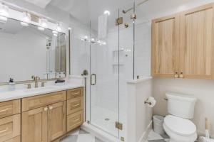 a bathroom with a shower and a toilet and a sink at Chelles in Bay St. Louis in Bay Saint Louis +13 photos