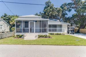 a house with a screened in porch on a yard at Chelles in Bay St. Louis in Bay Saint Louis