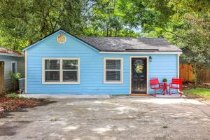 a blue house with two red chairs in a driveway at Cozy 1BR Studio Cottage in Avondale Prime Location in Miramar Terrace