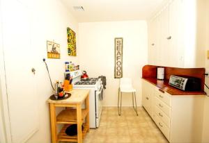 a kitchen with a stove and a table in it at The Marlowe Family Suite in Santa Barbara